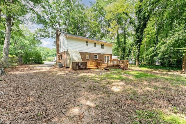 1 Red Fern Ct, Greensboro, NC 27455 - rear view of property featuring a wooden deck, a chimney, brick siding, and central air condition unit