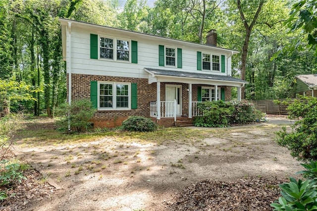 1 Red Fern Ct, Greensboro, NC 27455 - view of front of house with a chimney, brick siding, and covered porch