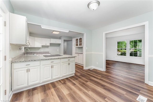 1 Red Fern Ct, Greensboro, NC 27455 - kitchen featuring a sink, white cabinets, a peninsula, dark wood-style floors, and baseboards