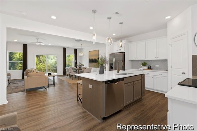6926 Baler Way Unit 19, Thomasville, NC 27360 - kitchen with appliances with stainless steel finishes, open floor plan, tasteful backsplash, dark wood-type flooring, and white cabinetry