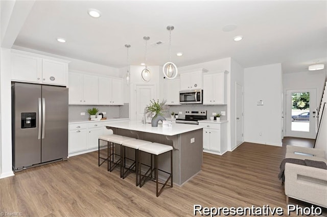 6926 Baler Way Unit 19, Thomasville, NC 27360 - kitchen with stainless steel appliances, wood finished floors, light countertops, and recessed lighting