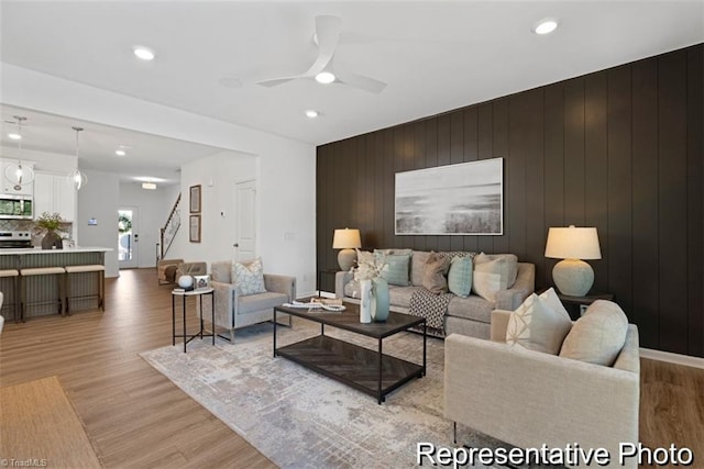 6926 Baler Way Unit 19, Thomasville, NC 27360 - living area with light wood-style flooring, a ceiling fan, stairs, recessed lighting, and wooden walls
