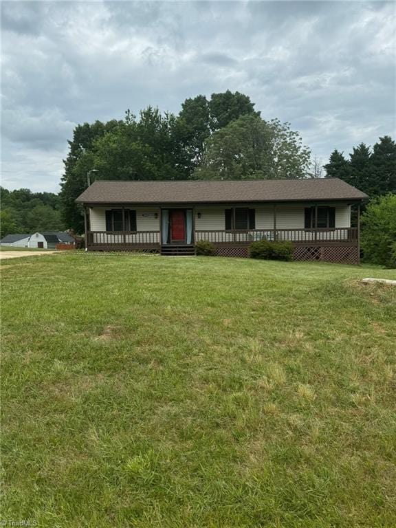 view of front of house with a deck and a front yard