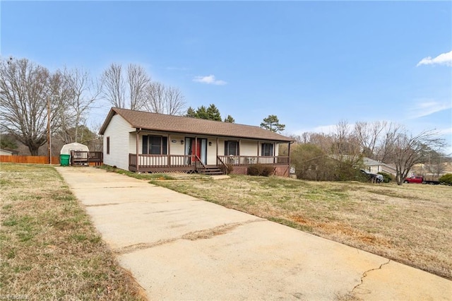 view of front facade with driveway, a front lawn, and a porch