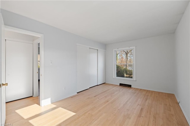 unfurnished room with light hardwood / wood-style floors