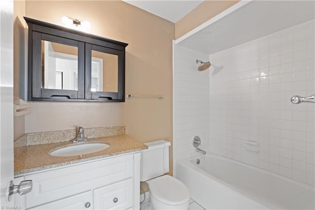 full bathroom with toilet, tiled shower / bath, and vanity