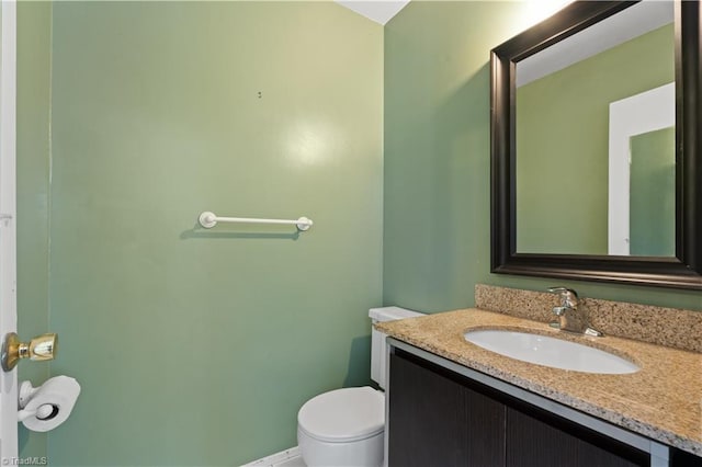 bathroom featuring toilet and vanity