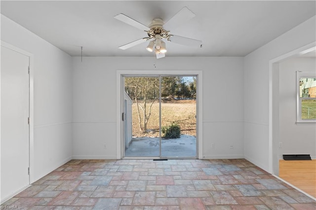 unfurnished room with ceiling fan and a wealth of natural light