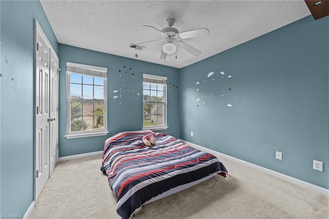 6416 Rock Springs Rd, Greensboro, NC 27410 - carpeted bedroom featuring a textured ceiling, ceiling fan, and a closet