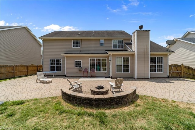 6416 Rock Springs Rd, Greensboro, NC 27410 - rear view of house with a patio, an outdoor fire pit, a fenced backyard, and a chimney