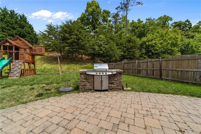 6416 Rock Springs Rd, Greensboro, NC 27410 - view of patio featuring a playground and exterior kitchen