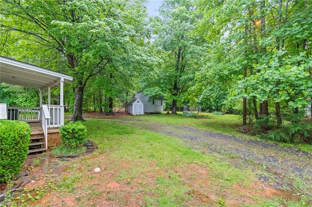 2796 Grant Trl, Randleman, NC 27317 - view of green lawn featuring a storage unit, an outdoor structure, and a wooden deck