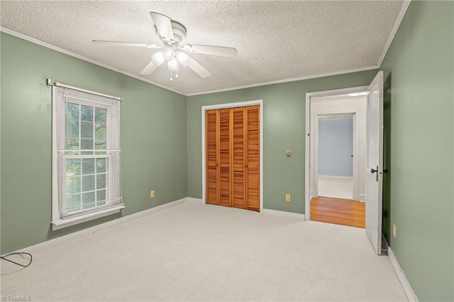 2796 Grant Trl, Randleman, NC 27317 - unfurnished bedroom with crown molding, a closet, a textured ceiling, carpet flooring, and ceiling fan