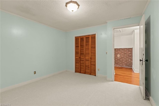 2796 Grant Trl, Randleman, NC 27317 - unfurnished bedroom featuring a textured ceiling, crown molding, a closet, carpet, and baseboards