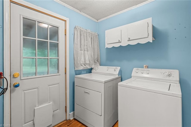 2796 Grant Trl, Randleman, NC 27317 - laundry room featuring washing machine and dryer, a textured ceiling, crown molding, and light wood-type flooring
