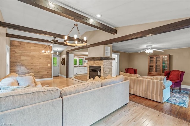 2796 Grant Trl, Randleman, NC 27317 - living area with a chandelier, baseboards, hardwood / wood-style floors, a stone fireplace, and ceiling fan