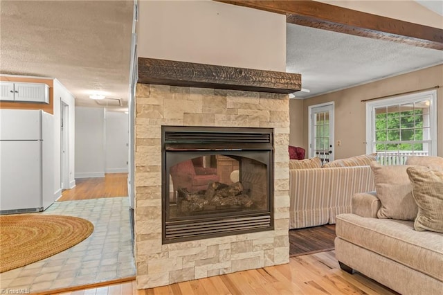 2796 Grant Trl, Randleman, NC 27317 - living area with light wood-style floors, a textured ceiling, and a fireplace