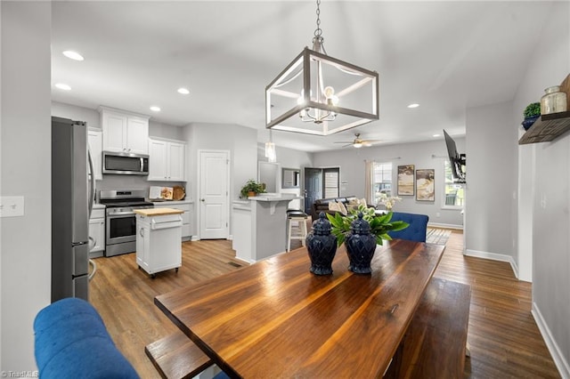 4215 Chippenham Ct, Graham, NC 27253 - dining area with baseboards, dark wood-style floors, recessed lighting, a chandelier, and a ceiling fan