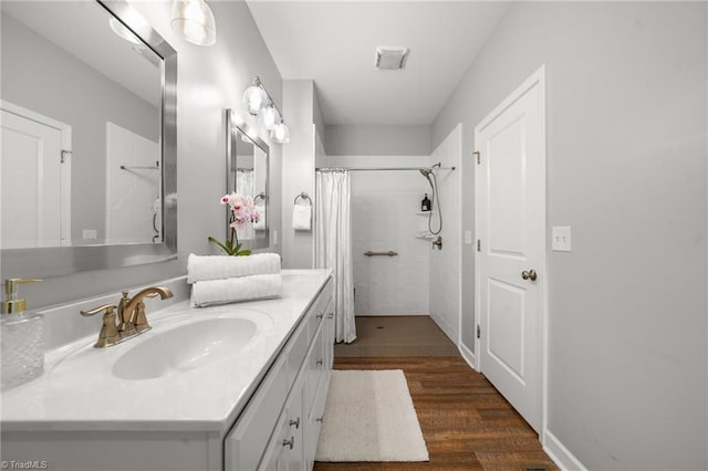 4215 Chippenham Ct, Graham, NC 27253 - full bath with vanity, wood finished floors, and curtained shower