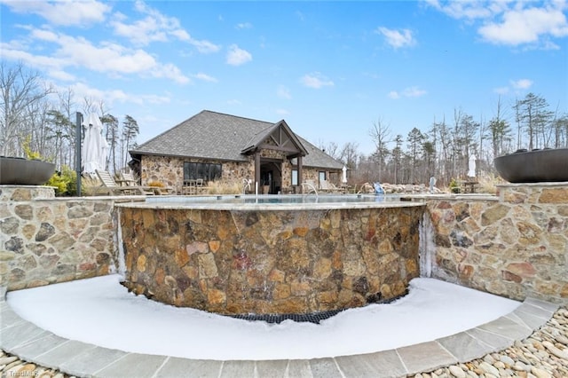 snow covered pool with a fireplace