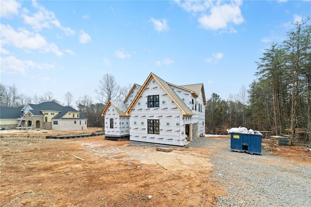 rear view of property featuring a garage