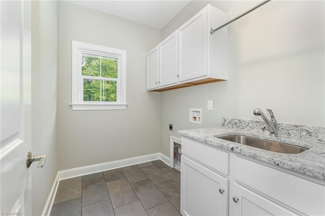 laundry room with hookup for a washing machine, hookup for an electric dryer, a sink, baseboards, and cabinet space