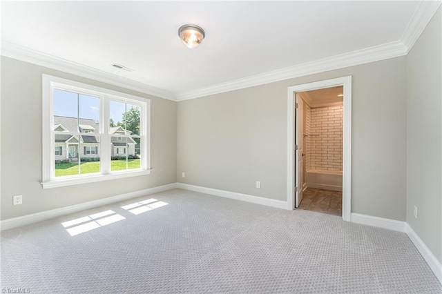 spare room with light carpet, visible vents, and crown molding