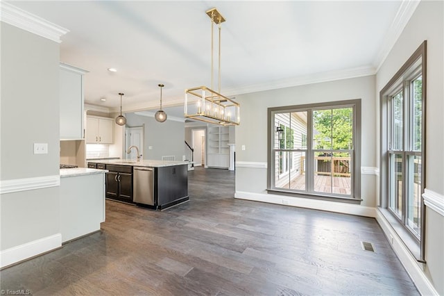 kitchen with a center island with sink, light countertops, visible vents, stainless steel dishwasher, and ornamental molding