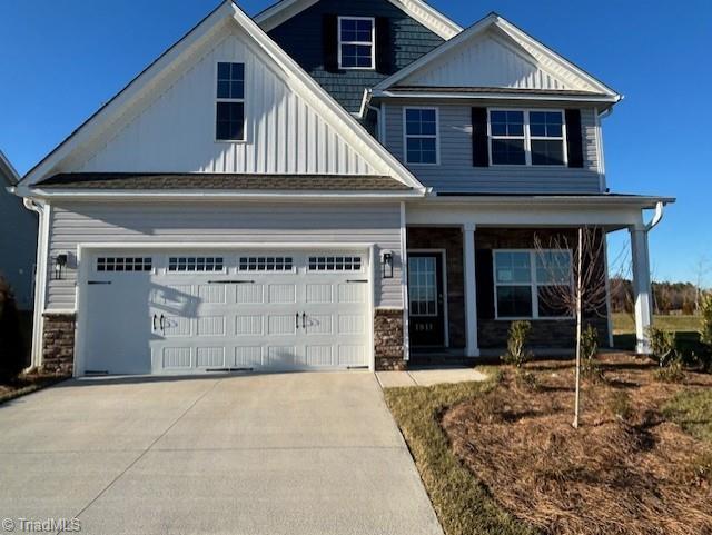 1911 Darrell Dr Lot # 4, Graham, NC 27253 - craftsman inspired home featuring concrete driveway, a porch, board and batten siding, an attached garage, and stone siding