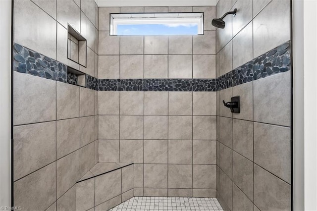 bathroom with tiled shower