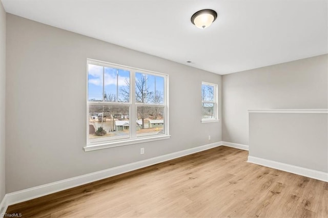 unfurnished room with light hardwood / wood-style flooring