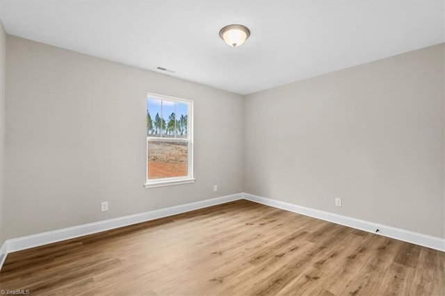 spare room featuring hardwood / wood-style floors