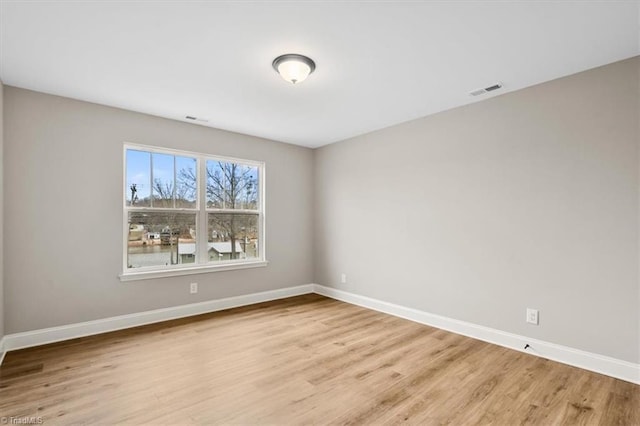 empty room with light hardwood / wood-style flooring