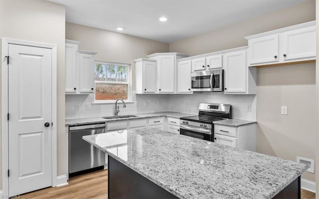 kitchen featuring white cabinetry, stainless steel appliances, and sink