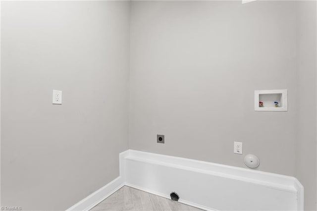 laundry area with gas dryer hookup, hookup for an electric dryer, laundry area, washer hookup, and baseboards