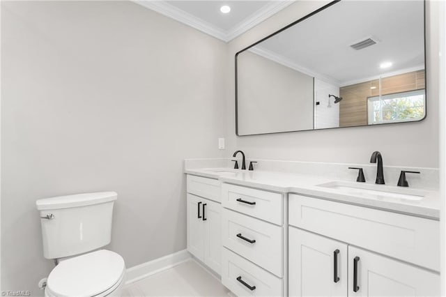 bathroom featuring double vanity, ornamental molding, a sink, and toilet