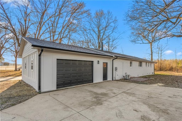 view of side of home featuring a garage, driveway, and board and batten siding