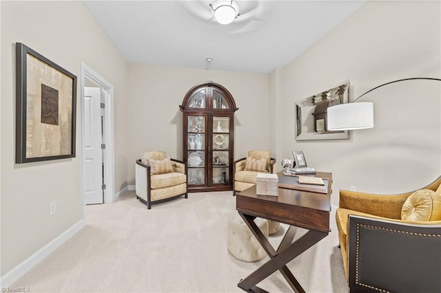 sitting room featuring light colored carpet