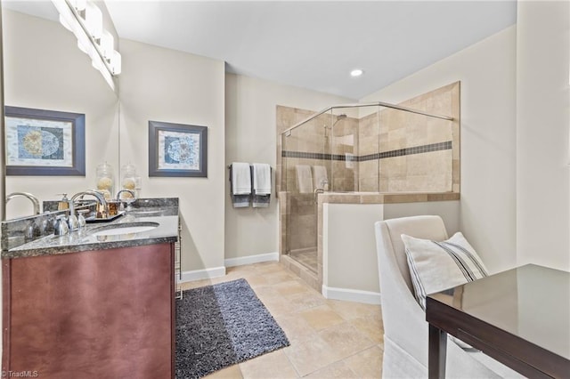 bathroom featuring a shower with door and vanity