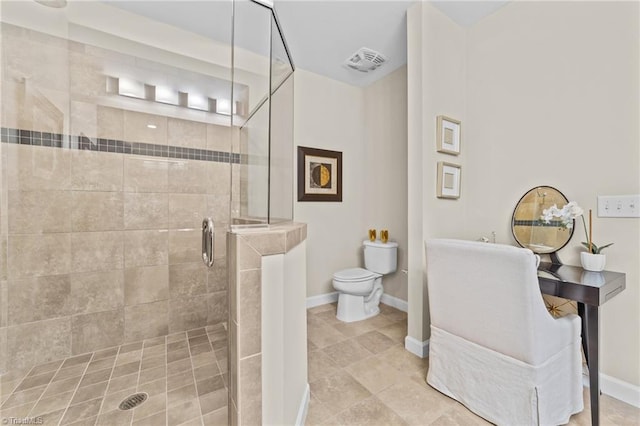 bathroom with an enclosed shower and toilet