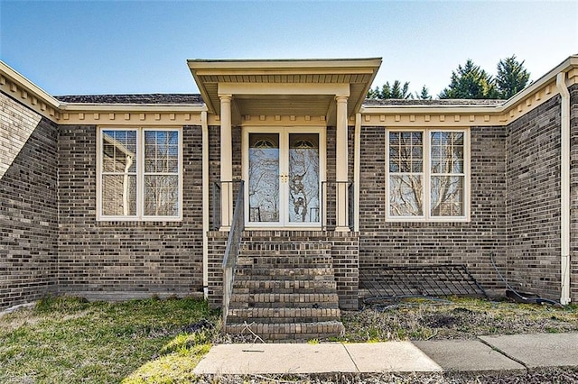 doorway to property featuring brick siding