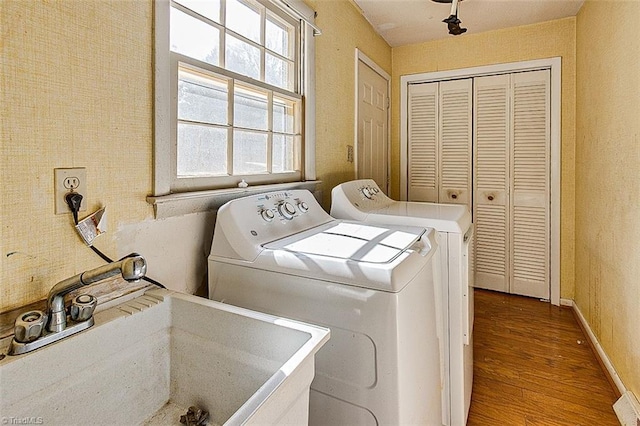 laundry room featuring dark wood-style floors, baseboards, laundry area, separate washer and dryer, and a sink