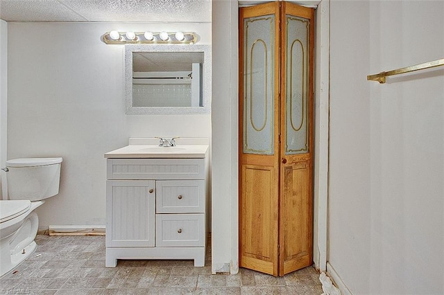 full bath featuring vanity, toilet, and baseboards