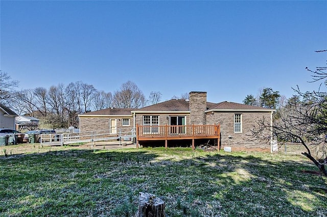 rear view of house featuring a chimney, a lawn, a wooden deck, and fence