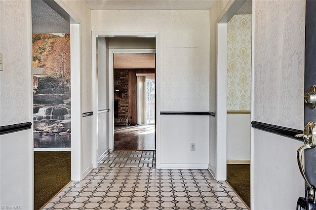 interior space with tile patterned floors and a textured ceiling