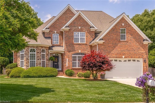 230 Lee Smith Ln, Kernersville, NC 27284 - traditional-style house featuring concrete driveway, brick siding, a front yard, and an attached garage