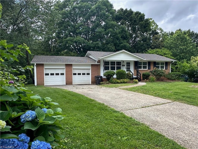 1230 W Sedgefield Dr, Winston-Salem, NC 27107 - single story home featuring brick siding, a front lawn, an attached garage, and driveway
