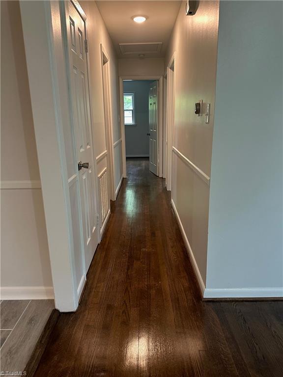 1230 W Sedgefield Dr, Winston-Salem, NC 27107 - hall with dark wood-type flooring, baseboards, and attic access