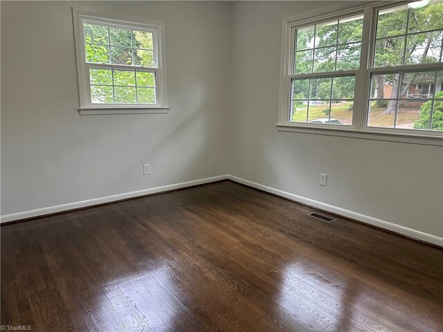 1230 W Sedgefield Dr, Winston-Salem, NC 27107 - spare room with baseboards and dark wood-type flooring