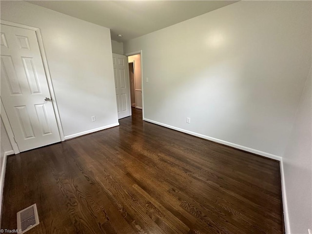 1230 W Sedgefield Dr, Winston-Salem, NC 27107 - unfurnished bedroom with dark wood-style flooring and baseboards